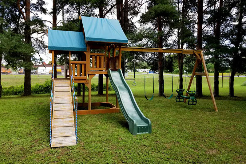 wooden playset with blue roof
